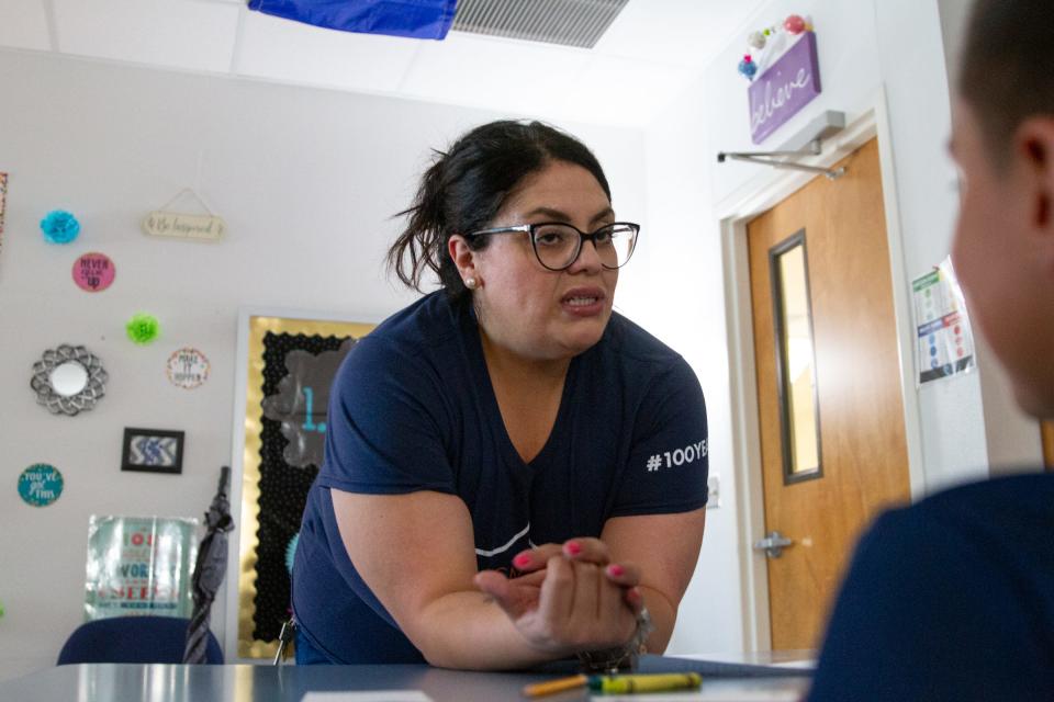 Jennifer Galindo, recipient of the national Amazing Teacher of the month award for July, helps create name cards for third-grade students at Desert Hills Elementary School on Aug. 7 in Horizon City.