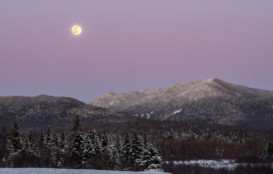 The Snow Moon rises about Pitchoff and South Meadows in the Adirondack Park, NY.