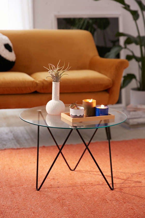 For under $170, <a href="https://www.urbanoutfitters.com/shop/anderson-glass-coffee-table?category=tables&amp;color=001" target="_blank">this round coffee table with its modern hairpin legs</a> works in any space.