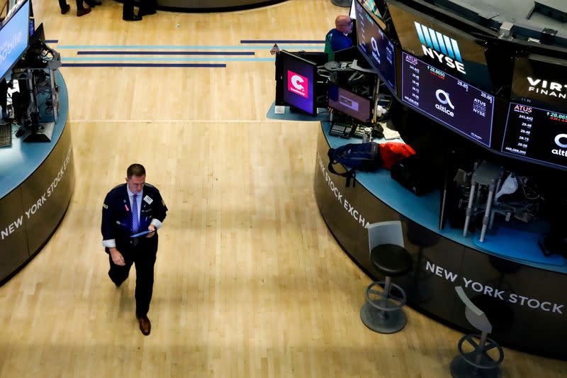 FILE PHOTO: Traders work on the floor at the NYSE in New York