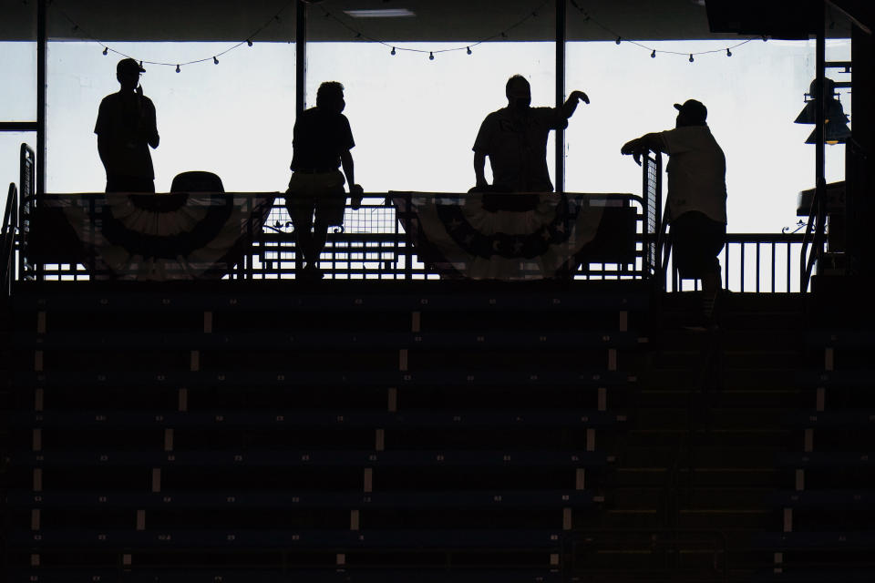 Tampa Bay Rays fans are silhouetted as they gather before Game 2 of an American League wild-card baseball series against the Toronto Blue Jays Wednesday, Sept. 30, 2020, in St. Petersburg, Fla. (AP Photo/Chris O'Meara)