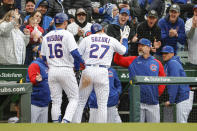 Chicago Cubs' Seiya Suzuki (27) is congratulated by manager David Ross, right, after scoring against the Milwaukee Brewers during the fifth inning of a baseball game, Thursday, April 7, 2022, in Chicago. (AP Photo/Kamil Krzaczynski)