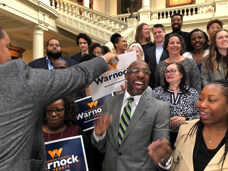 The Rev. Raphael Warnock, a Georgia Democrat, greets supporters at the state Capitol in Atlanta on Friday, March 6, 2020. Warnock filed paperwork to appear on the Nov. 3 ballot for Georgiaâ€™s special U.S. Senate election. / Credit: Benjamin Nadler / AP