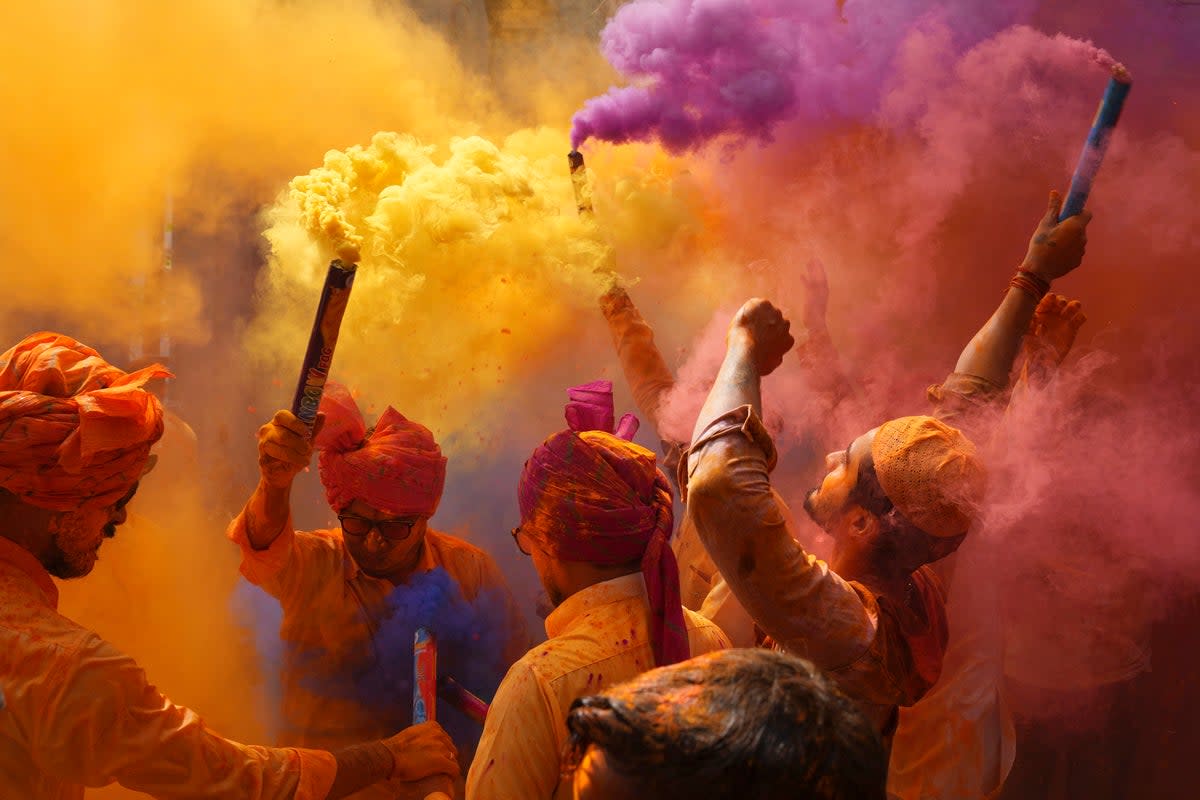 People sing, dance and throw colors at each other to celebrate Holi festival in Hyderabad, India (AP)
