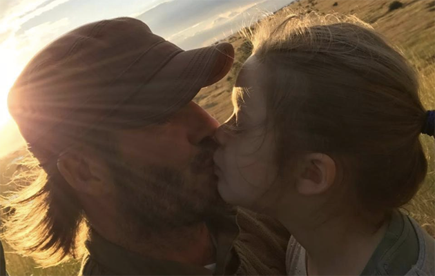 David Beckham has hit back at fans who slammed this image of him kissing his five-year-old daughter, Harper. Photo: Instagram