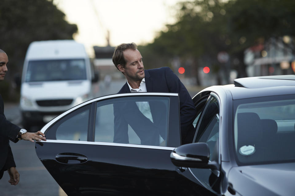 A man getting into a car