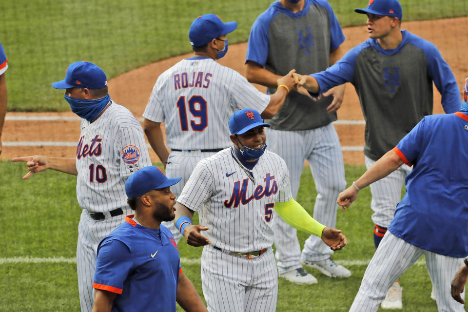 New York Mets' Yoenis Cespedes, center, celebrates with teammates after a baseball game against the Atlanta Braves at Citi Field, Friday, July 24, 2020, in New York. (AP Photo/Seth Wenig)