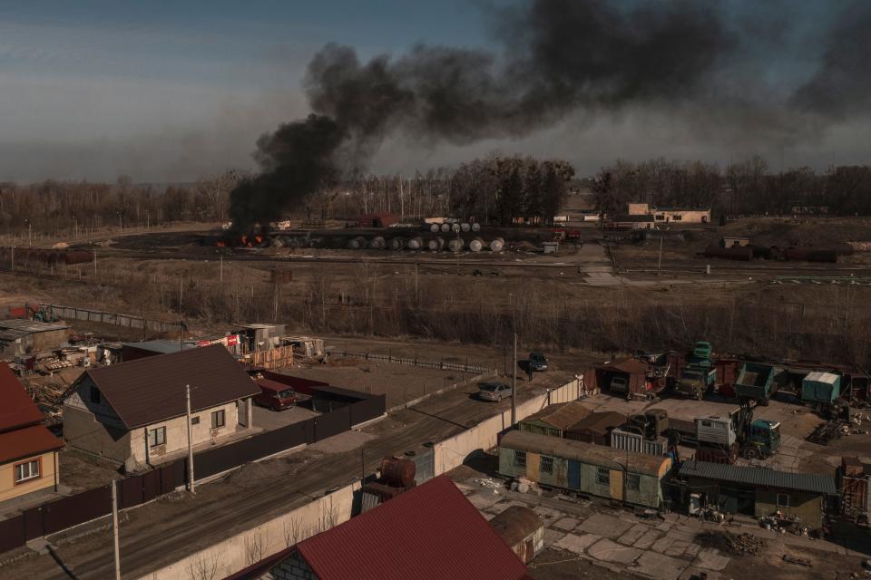 Smoke billows from burning containers after shelling in Vasylkiv, south west of Kyiv, Ukraine, Saturday, March 12, 2022. \