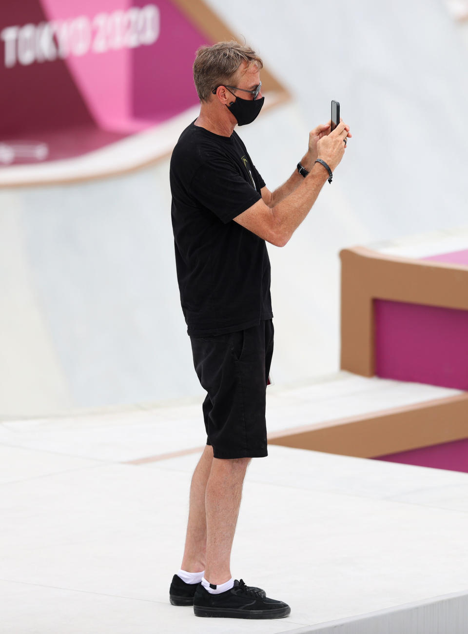 Tony at the 2020 Tokyo Olympics at the skateboard competition taking photos with his phone