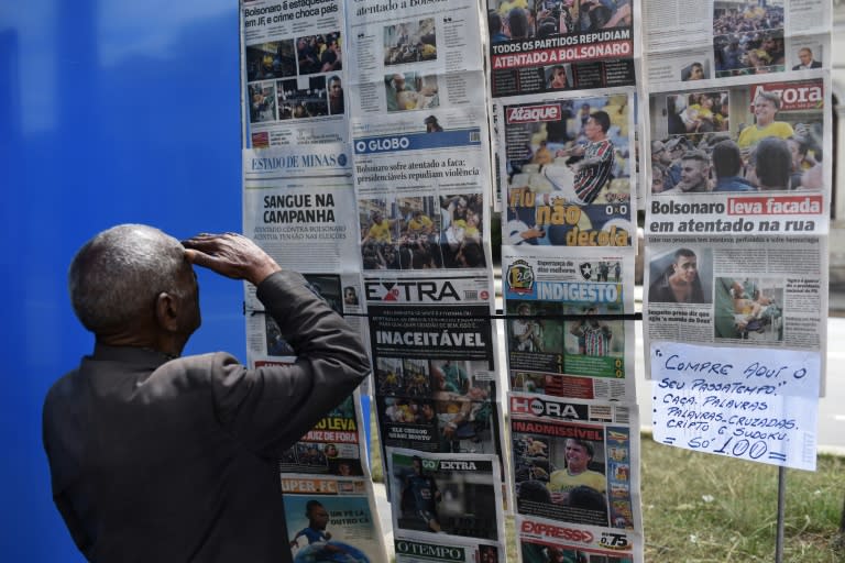 A man looks at the front pages of newspapers about the attack against Brazilian presidential candidate Jair Bolsonaro