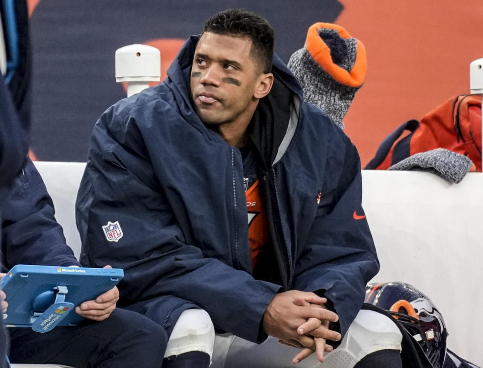 FILE - Denver Broncos quarterback Russell Wilson sits on the bench during the second half of an NFL football game against the Los Angeles Chargers, Sunday, Dec. 31, 2023, in Denver.  Denver believed in Wilson so strongly that the Broncos gave him a five-year, $245 million extension before he played a game for them, even though he had two years left on his contract.  (AP Photo/David Zalubowski, File)