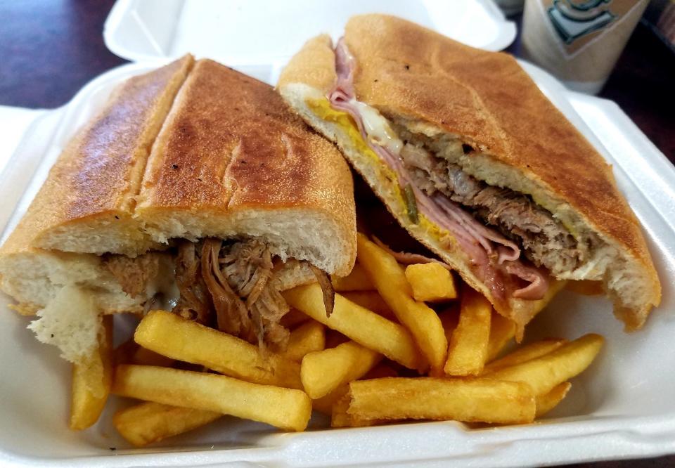 Quetzel's Cuban sandwich was freshly pressed Cuban bread stuffed full of succulent roasted pork and layers of ham and swiss cheese, pickles, and zesty mustard.