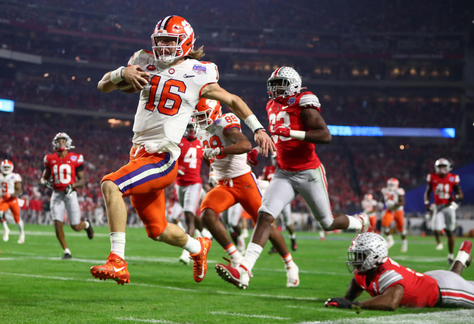 Dec 28, 2019; Glendale, AZ, USA; Clemson Tigers quarterback Trevor Lawrence (16) scores a touchdown against the Ohio State Buckeyes during the first half in the 2019 Fiesta Bowl college football playoff semifinal game at State Farm Stadium. Mandatory Credit: Mark J. Rebilas-USA TODAY Sports     TPX IMAGES OF THE DAY