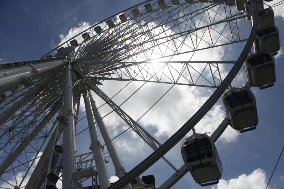 SkyView, a 200-foot tall Ferris wheel, gives riders a bird's-eye view of Atlanta, Tuesday, July 16, 2013, in Atlanta. The giant ferris wheel opened to the public Tuesday. (AP Photo/Jaime Henry-White)