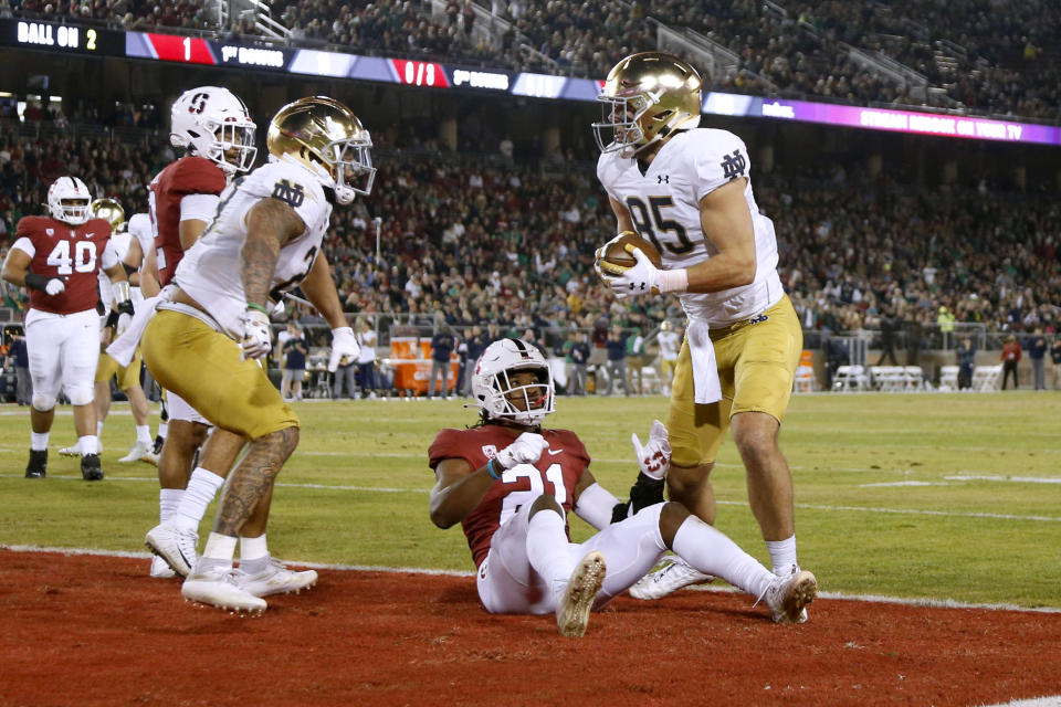 Notre Dame's George Takacs (85) makes a touchdown reception against Stanford's Kendall Williamson (21) during the first half of an NCAA college football game in Stanford, Calif., Saturday, Nov. 27, 2021. (AP Photo/Jed Jacobsohn)