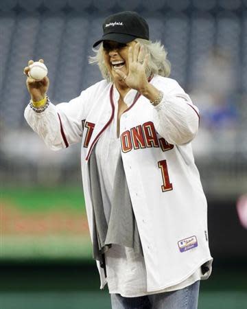 Food Network personality Paula Deen laughs before throwing out the first pitch prior to the Washington Nationals versus New York Mets MLB baseball game in Washington, May 19, 2010. REUTERS/Gary Cameron