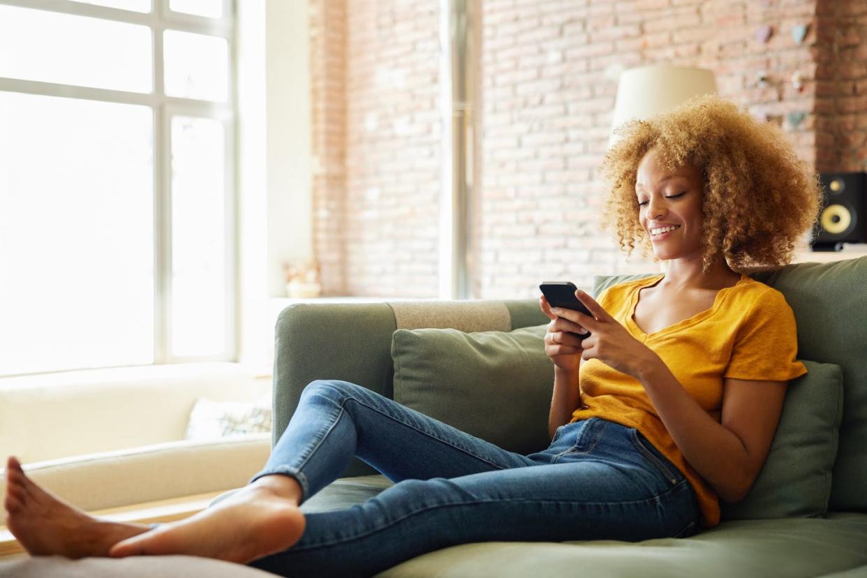 A new book titled 'The Love Jones Cohort' examines the lifestyles of middle-class Black Americans. <a href="https://www.gettyimages.com/detail/photo/african-american-woman-using-social-media-on-smart-royalty-free-image/1432253560" rel="nofollow noopener" target="_blank" data-ylk="slk:Morsa Images/DigitalVision Collection/Getty Images;elm:context_link;itc:0;sec:content-canvas" class="link ">Morsa Images/DigitalVision Collection/Getty Images</a>