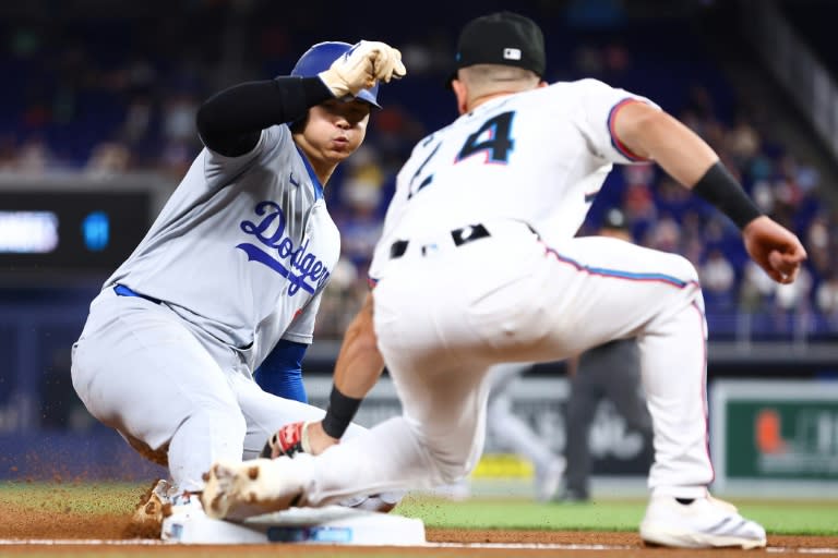 Los Angeles Dodgers star Shohei Ohtani beats the tag by Miami Marlins third baseman Connor Norby to post his 50th stolen base of the MLB season (Megan Briggs)