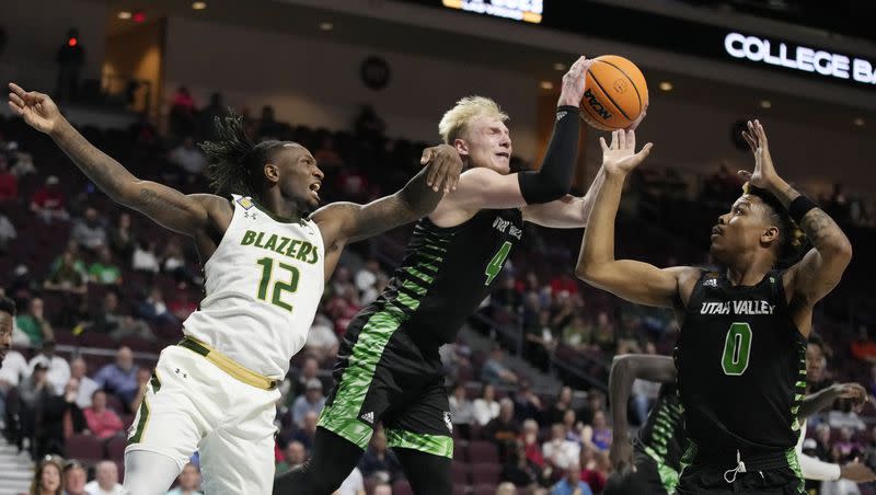 Utah Valley’s Trey Woodbury (4) grabs a rebound over UAB’s Tony Toney (12) during the first half of an NCAA college basketball game in the semifinals of the NIT, Tuesday, March 28, 2023, in Las Vegas.