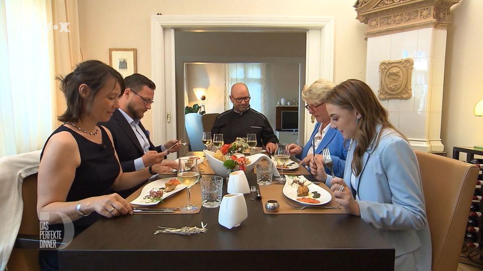 Als Vorspeise liegt ein Dreierlei von Fisch auf dem Teller, von links: Kirsten, Marius, Gastgeber André, Tine und Hannah.
 (Bild: RTL)