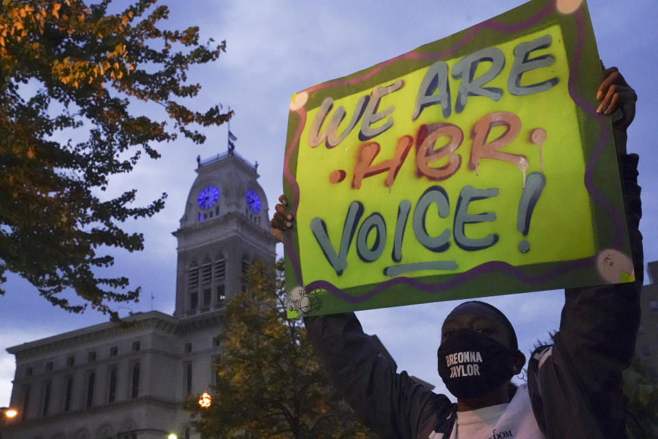 A protester stands in Jefferson Square, Thursday, Sept. 24, 2020, in Louisville, Ky. Authorities pleaded for calm while activists vowed to fight on Thursday in Kentucky's largest city, where a gunman wounded two police officers during anguished protests following the decision not to charge officers for killing Breonna Taylor. (AP Photo/John Minchillo)