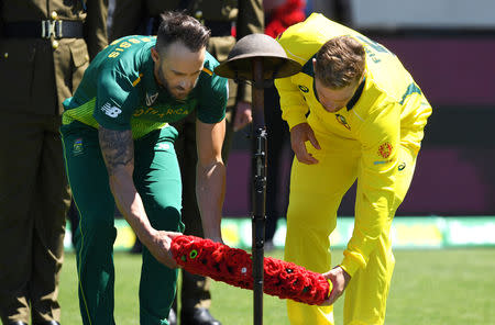 Australia's captain Aaron Finch and South Africa's captain Faf du Plessis lay a wreath during a memorial service to mark the centenary of the Armistice ending World War One before the start of the third one-day international at Bellerive Oval in Hobart, Australia, November 11, 2018. AAP/Dean Lewins/via REUTERS