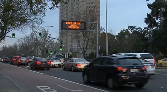 Signs reminding drivers not to Pokemon and drive. Source: 7News