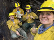 Lucas Galloway, from left, Jaebyn Drake, Rhett Schieder and Audrey Wilcox pose for a selfie with Baby Yoda on Sept. 20, 2020, while fighting the Holiday Farm Fire in Blue River, Oregon. Beleaguered firefighters in the western United States have a new force on their side: Baby Yoda. In early September, A 5-year-old Oregon boy named Carver and his grandmother delivered a toy version of “The Mandalorian” character to a donation center for firefighters. The toy came with a handwritten note from Carver saying the toy was meant to be “a friend” in case they got lonely. Since then, Baby Yoda has been to four wildfires in two states. (Courtesy of Audrey Wilcox via AP)