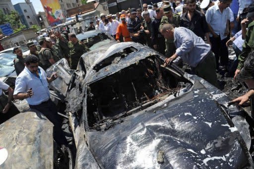 Syrians gather at the scene of two huge bomb explosions outside the Palace of Justice in Damascus. Deadly violence raged across the country and Turkey reinforced its volatile border with Syria with missile batteries