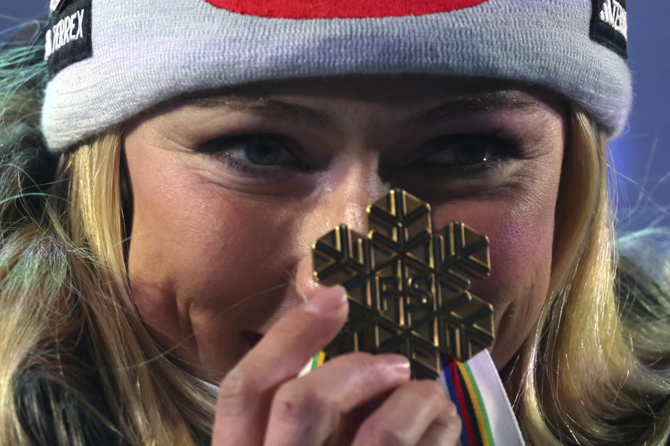 United States' Mikaela Shiffrin shows the gold medal of the women's World Championship giant slalom, in Meribel, France, Thursday Feb. 16, 2023. (AP Photo/Alessandro Trovati)