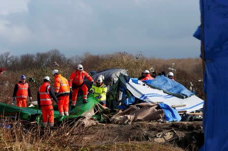 Workmen tear down makeshift shelters during the dismantlement of the migrant shanty town called the "Jungle" in Calais, France, March 3, 2016. REUTERS/Yves Herman