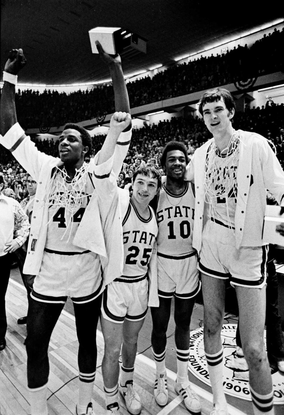 NC State’s David Thompson, Monte Towe, Mo Rivers and Tommy Burleson celebrate after the 1974 Wolfpack defeated Marquette to win the National Championship.