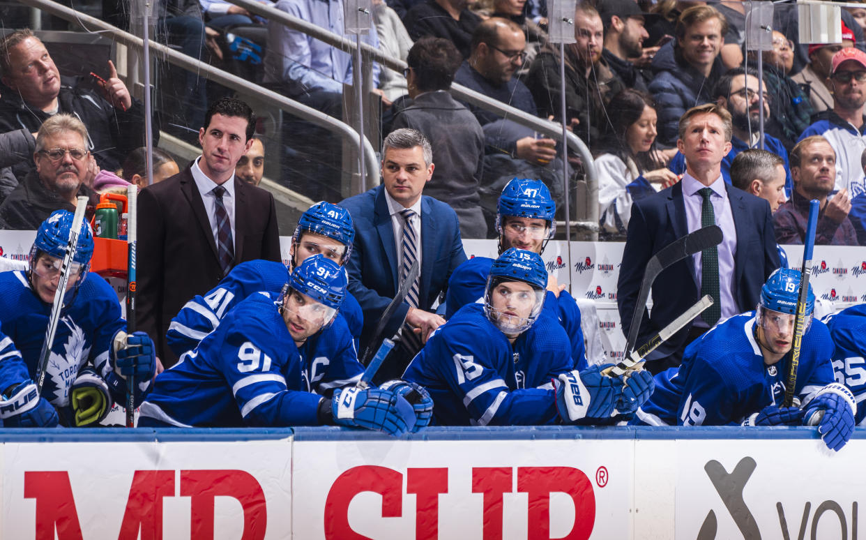 TORONTO, ON - DECEMBER 4: Head coach Sheldon Keefe, assistant coach Paul McFarland, and assistant coach Dave Hakstol of the Toronto Maple Leafs watch from the bench against the Colorado Avalanche during the third period at the Scotiabank Arena on December 4, 2019 in Toronto, Ontario, Canada. (Photo by Mark Blinch/NHLI via Getty Images)