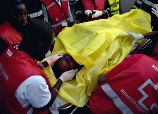 A victim of one of the attacks on churches in the Kenyan town of Garissa, near the border with Somalia, is wheeled by paramedics to a waiting ambulance after she was airlifted to Nairobi from the northeastern city. Gunmen killed 17 people and wounded dozens in gun and grenade attacks on two churches