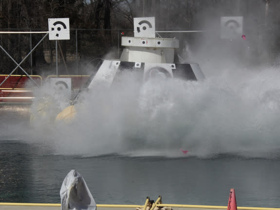 A CST-100 mock up splashes down during a test at NASA's Langley Research Center in Hampton, Va., during tests of the Boeing spacecraft's handling.