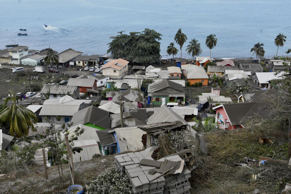 Volcanic ash covers the roofs of homes after the eruption of La Soufriere volcano in Wallilabou, on the western side of the Caribbean island of St. Vincent, Monday, April 12, 2021. La Soufriere volcano fired an enormous amount of ash and hot gas early Monday in the biggest explosive eruption yet since volcanic activity began on the eastern Caribbean island of St. Vincent late last week. (AP Photo/Orvil Samuel)