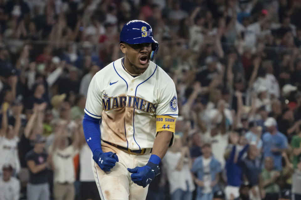 Seattle Mariners' Julio Rodriguez celebrates while rounding the bases after hitting a solo home run off Atlanta Braves relief pitcher Kenley Jansen during the ninth inning of a baseball game, Sunday, Sept. 11, 2022, in Seattle. The Mariners won 8-7. (AP Photo/Stephen Brashear)