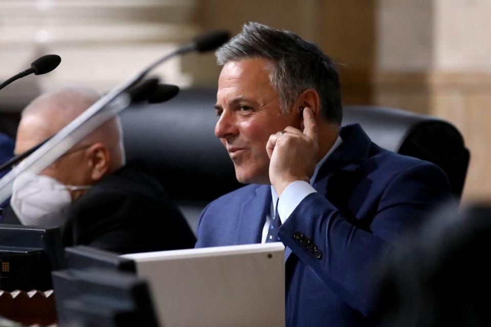 Councilmember Joe Buscaino listens to public comment on an earphone.