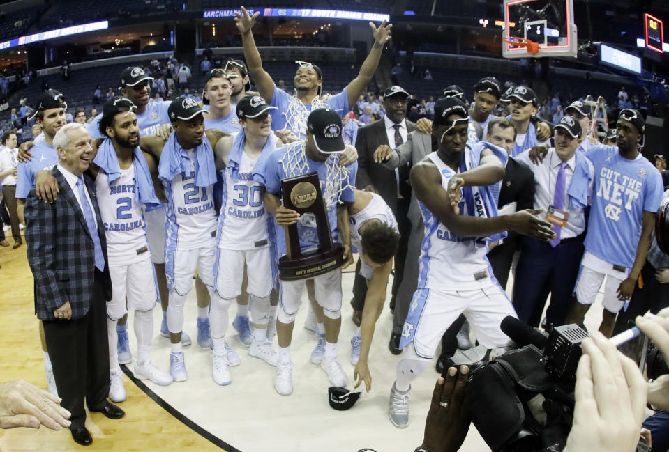 North Carolina players and coaches celebrate after beating Kentucky 75-73 to win the South Regional final game in the NCAA college basketball tournament Sunday, March 26, 2017, in Memphis, Tenn. (AP Photo/Mark Humphrey)