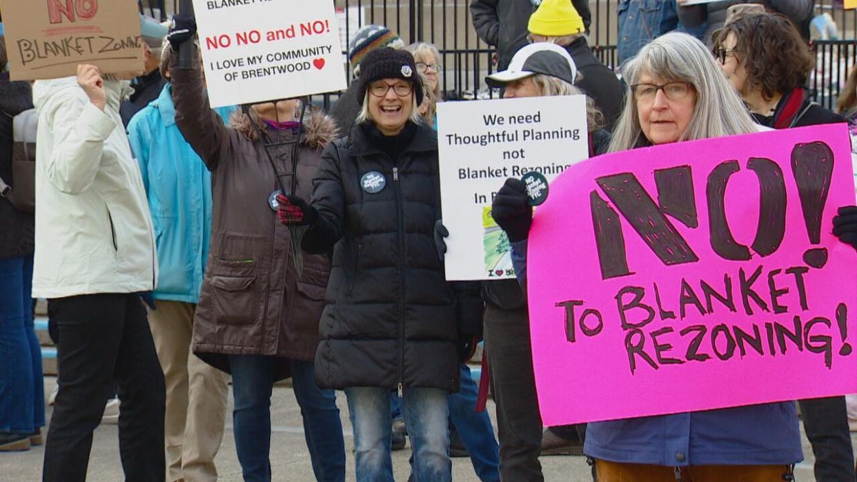 Homeowners protested against the proposed Calgary-wide rezoning of residential homes to permit more duplexes and townhouses on the first day of a lengthy public hearing at City Hall. (Anne-Marie Trickey/CBC - image credit)