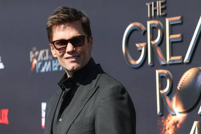 Man in dark formal attire with sunglasses at 'The Great' premiere event