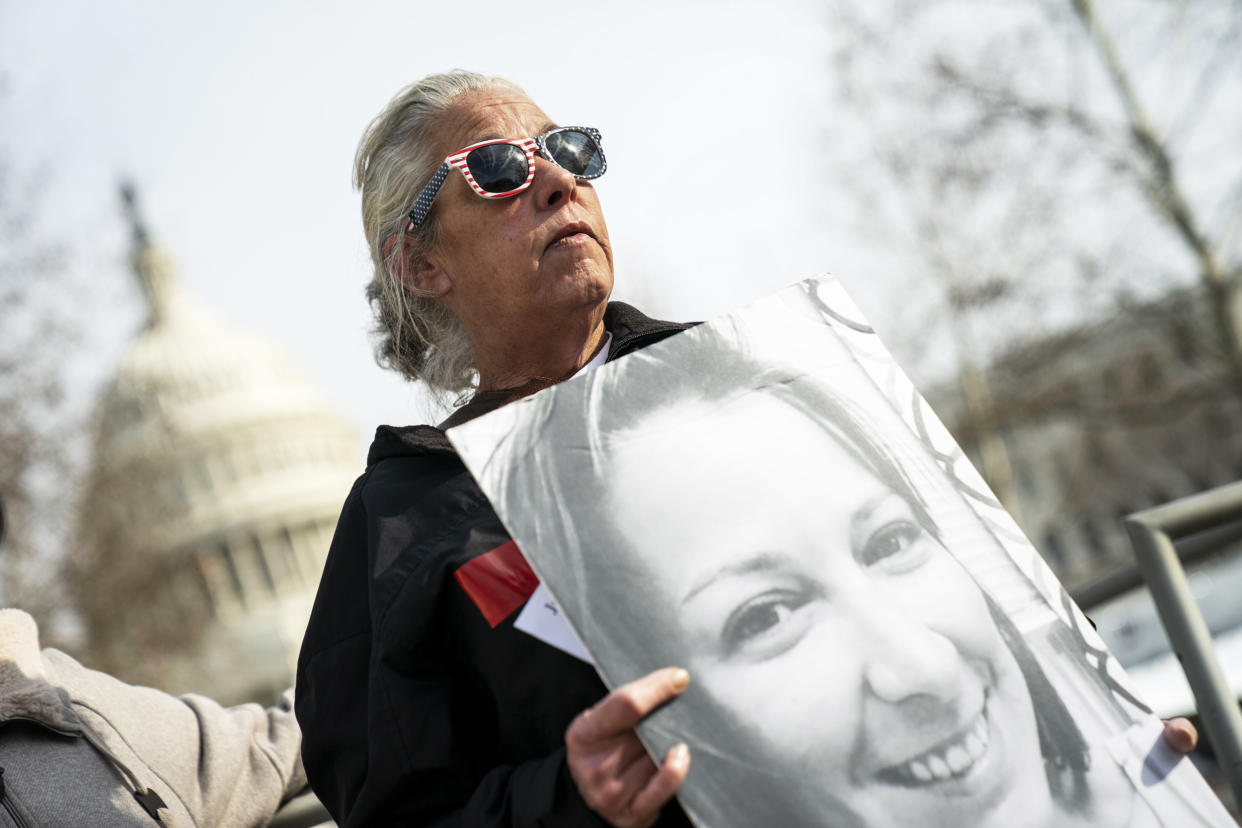 Micki Witthoeft holds a photograph of her late daughter Ashli Babbitt during a protest at the Capitol (Kent Nishimura / Los Angeles Times via Getty Images file)