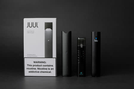 An electronic cigarette device made by JUUL (L) is shown next to other similar devices (R to L) myblu, Suorin ishare and Vuse Alto in this photo illustration taken September 20, 2018. REUTERS/Mike Blake/Illustration