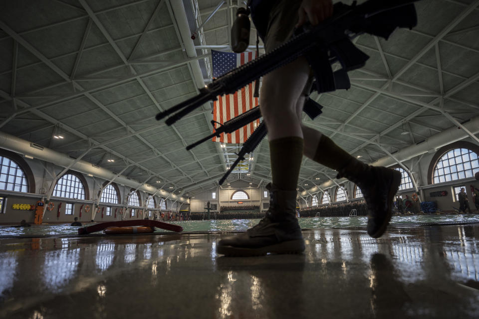 A group of U.S. Marine Corps recruits march back into formation at the Marine Corps Recruit Depot pool during integrated swim training, Wednesday, June 28, 2023, in Parris Island, S.C. (AP Photo/Stephen B. Morton)