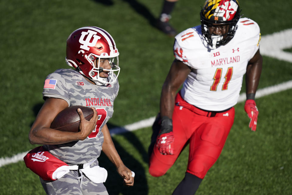 Indiana quarterback Michael Penix Jr. (9) is chased by Maryland's Ruben Hyppolite II (11) during the second half of an NCAA college football game, Saturday, Nov. 28, 2020, in Bloomington, Ind. Indiana won 27-11. (AP Photo/Darron Cummings)