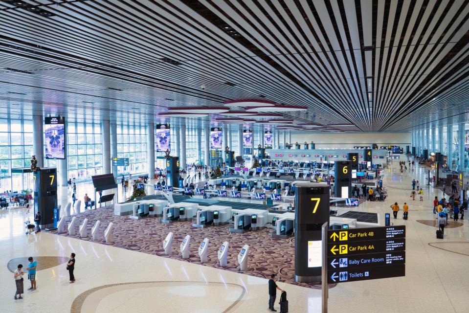 Automated luggage drop-off machines stand in the departure hall at Terminal 4 (T4) of Changi Airport in Singapore, on Thursday, Dec. 13, 2018. 