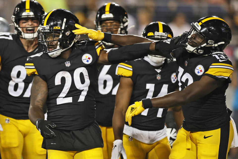 Pittsburgh Steelers running back Kalen Ballage (29) celebrates with wide receiver James Washington (13) after Ballage scored a 4-yard touchdown during the second half against the Dallas Cowboys in the Pro Football Hall of Fame NFL preseason game Thursday, Aug. 5, 2021, in Canton, Ohio. (AP Photo/Ron Schwane)