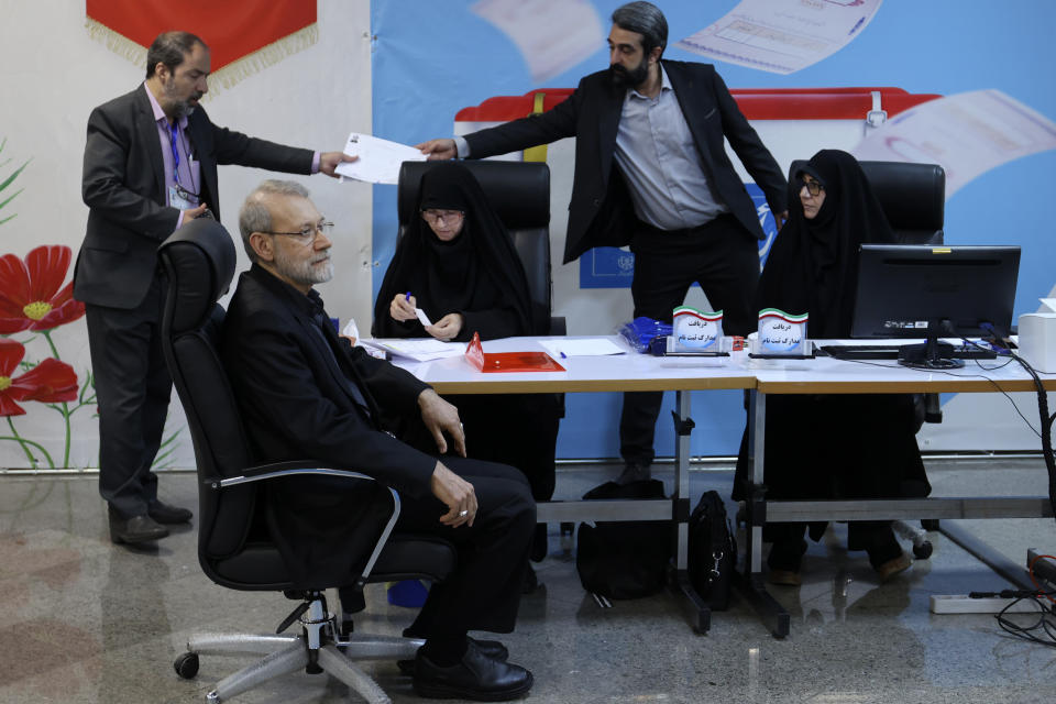 Iran's former parliament speaker Ali Larijani, left, sits while registering his name as a candidate for the June 28 presidential elections at the Interior Ministry in Tehran, Iran, Friday, May 31, 2024. Larijani registered Friday as a possible candidate in the Islamic Republic's presidential election to replace the late Ebrahim Raisi, who was killed in a helicopter crash earlier this month with seven others. (AP Photo)