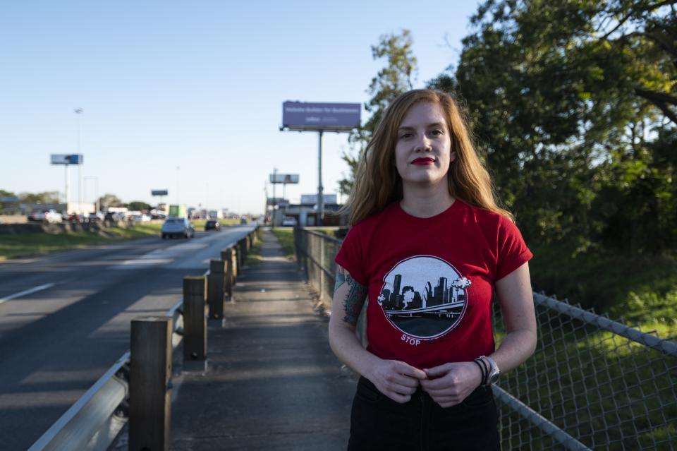 Molly Cook, an organizer with Stop TxDOT I-45, on the Interstate 45 frontage road Friday, Nov. 19, 2021, in Houston. A $9 billion highway widening project being proposed in the Houston area could become an important test of the Biden administration’s commitment to addressing what it says is a history of racial inequity with infrastructure projects. (AP Photo/Justin Rex)