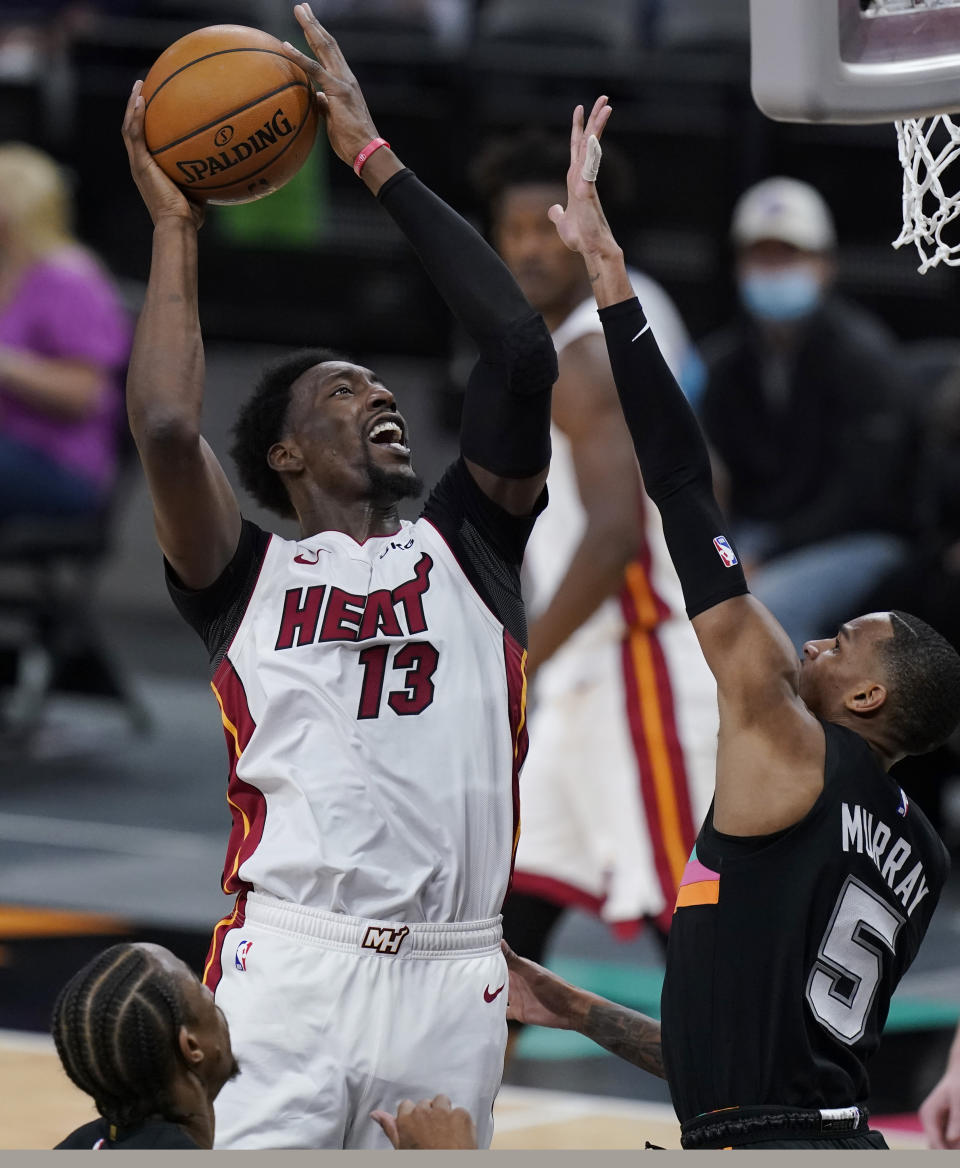 Miami Heat center Bam Adebayo (13) shoots over San Antonio Spurs guard Dejounte Murray (5) during the second half of an NBA basketball game in San Antonio, Wednesday, April 21, 2021. (AP Photo/Eric Gay)